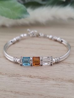 a bracelet with three different colored stones on it