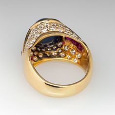 This exquisite ring is centered with an oval, sapphire cabochon in a partial bezel setting. The shoulders are each channel set with four (4) square mixed cut rubies. The top of the ring is bead set with a total of forty-six (46) round brilliant cut diamonds. The ring measures 13.7mm at the top, rises 11.2mm above the finger, tapering to 5.5mm wide and 1.3mm thick at the base of the shank. This ring is currently a size 7. Ruby Diamond Ring, Sapphire Cabochon, Ruby Diamond Rings, Bead Set, Ruby Diamond, Channel Set, Round Brilliant Cut Diamond, Bezel Setting, Round Brilliant