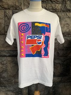 "Vintage 90s PEPSI Pop Art Design t-shirt Item Condition: Pre-Owned (Used) condition. please see pictures Size on Tag: M, Please check measurement Tag : ------------ Measurement: ------------- Chest (Pit to Pit) 20\" Length 27\" Shipping: Worldwide ---------- Standard Shipping 14-30 Days Express 5-8 Days I can do combined shipping +Add USD 5 shipping for each additional items!" Pop Culture Letter Print Shirt, Cheap Pop Culture T-shirt With Custom Artwork, White Retro Print T-shirt For Streetwear, 90s Style Screen Print T-shirt, White Retro T-shirt With Graffiti Print, 90s Inspired White Graphic T-shirt, 90s Style White Tops With Vintage Print, Vintage Multicolor Graffiti Print T-shirt, 90s Cotton T-shirt With Retro Print