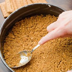 a person scooping something out of a pan