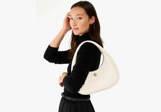 Done in soft pebbled leather our Kayla shoulder bag has a cool crescent silhouette and signature spade logo. | Kate Spade Kayla Crescent Shoulder Bag, Meringue Spade Logo, Kate Spade Outlet, Fall Essentials, Crossbody Wallet, Gummy Bears, Heeled Loafers, Watch Necklace, Kate Spade Bag, Meringue