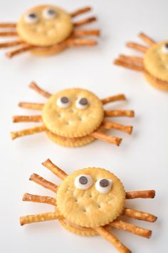 some cookies with googly eyes and spider legs on them are ready to be eaten