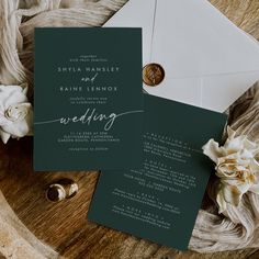 the wedding stationery is set on top of an envelope with a waxed seal