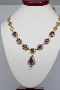 This exquisite necklace is part of my modern filigree collection. Filigree is an ancient, high-end jewelry making tradition. It involves tightly weaving wires of gold and silver to create inventive decorative patterns in jewelry.This particular necklace presents a modern twist on the ancient filigree designs. It is handmade using 14K gold to elegantly frame amethyst and diamond gemstones. The necklace contains 18 pts of diamonds and 22cts worth of amethyst. This necklace is customizable, so feel Yellow Gold Wire Wrapped Pendant Jewelry, Wire Wrapped Yellow Gold Pendant Jewelry, Elegant Brass Necklace With Intricate Design, Handmade Fine Jewelry For Ceremonial Occasions, Gold Oval Wire Wrapped Necklace, Oval Gold Wire Wrapped Necklaces, Oval Gold Wire Wrapped Necklace, Formal Yellow Gold Wire Wrapped Jewelry, Luxury Handmade Brass Necklaces