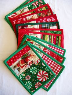 christmas themed placemats and napkins on a white tablecloth with candy canes