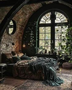 a bedroom with an arched window, bed and rugs on the floor in front of it