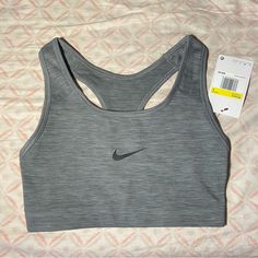 It Is Active Wear So It Is Used For Long Runs And Workouts The Color Is Grey And Can Match With Many Things. It Is New With Tags As I Am Had Bought It For Me Bad It Was The Wrong Size. Fitted Gray Sports Bra, Gray Casual Top For Light Exercise, Casual Gray Top For Light Exercise, Nike Gray Athletic Fit Activewear, Gray Supportive Workout Top, Gray Breathable Racerback Top, Gray Racerback Functional Top, Gray Workout Tops With Medium Support, Gray Functional Racerback Top