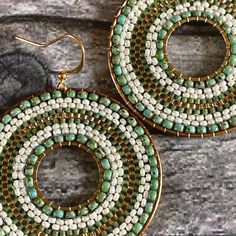 Beautiful boho style round statement earrings in shades of green and gold. Hand woven from miyuki seed beads. Perfect for summer.  As all jewellery is individually handmade, slight variations to the product in the image may occur. - Brass hoops - Gold plated ear wires  - Length: approximately 2 inches (5cm) Bohemian Green Circular Earrings, Green Bohemian Circle Earrings, Green Bohemian Beaded Earrings With Tiny Beads, Green Beaded Earrings For Summer, Bohemian Green Beaded Hoop Earrings, Bohemian Gold Beaded Round Earrings, Bohemian Gold Beaded Earrings, Beach Woven Green Jewelry, Bohemian Circle Earrings With Tiny Beads