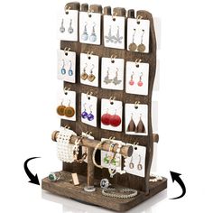 a wooden display with earrings and necklaces on it