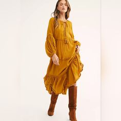 Free People In The Moment Midi Dress In Golden Glow, Sz M. Dress Is Tiered With Raw Hems/Seams & Balloon Sleeves. Knit Accent Trim Along Sleeves & Deep V Neckline With Tassle Ties Plus Loop & Button Closure. Oversized - Will Easily Work For A Size L. Measures Approx 26" Across Underarms & About 48" Length. Fabrication: 100% Rayon With 100% Cotton Contrast. Good Preowned Condition With A Bit Of Fraying Along The Raw Seams & One Small Spot On The Bodice (Pictured). Yellow Long Sleeve Maxi Dress With Ruffles, Yellow Midi Dress With Ruffles For Fall, Fall Yellow Midi Dress With Ruffles, Yellow Ruffled Long Sleeve Maxi Dress, Yellow Long Sleeve Ruffled Maxi Dress, Yellow Ruffled Midi Dress For Fall, Yellow Bohemian Long Sleeve Midi Dress, Yellow Long Sleeve Bohemian Midi Dress, Yellow Bohemian Maxi Dress For Fall