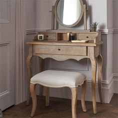 a vanity with a stool and mirror in a room