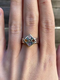 a close up of a person's hand with a ring on top of it