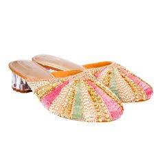 A Strip Of White Beads, Followed By Golden Sequins And Zardosi And Then One Of Either Pink Or Green Sallis Converging At The Centre To Resemble The Rays Of The Sun. These Rose Gold Mules Have Almost A Flower Shaped Transparent Heel With A Broad Base For Extra Comfort. This Pair Like Its Name Kiran Is Bound To Emit Radiance To Your Look. Suitable For- Dinners, Lunches, Casual Meetings, Festivals, And Semi-Formal Occasions Heel Size - 2 Inches Heel Type - Transparent Block Material - Silk,Wood,Pvc Multicolor Embellished Open Toe Heels, Multicolor Embellished Evening Sandals, Embellished Multicolor Evening Sandals, Evening Multicolor Embellished Sandals, Elegant Embellished Multicolor Sandals, Elegant Multicolor Embellished Sandals, Beaded Heels For Formal Summer Events, Summer Formal Beaded Heels, Multicolor Embellished Heels With Round Toe