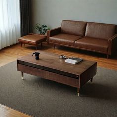 a living room with two couches and a coffee table in front of a window