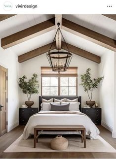 a large bed sitting under a wooden ceiling in a bedroom next to a window filled with potted plants