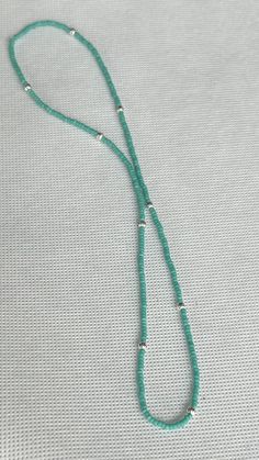 Made with turquoise Czech glass seed beads, with unique corrugated silver metallic beads on strong elastic cording. These delicate, simple, and classy stretchy Boho beaded necklaces go right over the head, without the hassle of a clasp. Embracing the beauty of simplicity, our seed bead necklaces feature subtle silver or gold-colored pendants inspired by the tranquility of the natural world. Each pendant is carefully chosen to complement the seed bead colors and enhance the necklace's aesthetic appeal. Also made with the same metal beads in gold. Adjustable Turquoise Beaded Necklace With Silver Beads, Adjustable Green Turquoise Necklace With Spacer Beads, Adjustable Turquoise Necklace With Silver Beads As A Gift, Minimalist Turquoise Single Strand Beaded Necklace, Adjustable Turquoise Beaded Necklace With Tiny Beads, Adjustable Turquoise Necklaces With Tiny Beads, Minimalist Turquoise Beaded Necklace With Tiny Beads, Adjustable Turquoise Heishi Beads Necklace, Adjustable Turquoise Heishi Beaded Necklaces