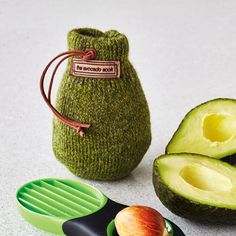 an avocado is sitting next to a green bag