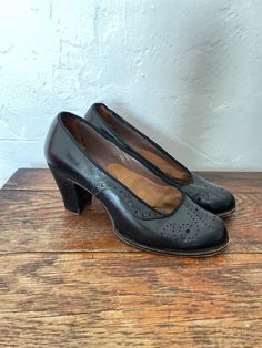 "Beautiful and classic and sturdy. 1930's day shoes  Perforated leather uppers  Grosgrain ribbon  trim Wood block heel Leather soles Label: F. Pinet of 47 New Bond St London Measurements:  inside toe to heel 9.5\" Inside width 2 3/4\" Heel height 2 3/4\" Fits like a UK 4 US 6 Condition: Very good and wearable. Some creasing and scuffing but no holes or cracks" Retro Court Shoes With 4-inch Heel Medium Width, Retro Court Shoes With 4-inch Heel And Medium Width, Retro Court Shoes With 4-inch Heel In Medium Width, Vintage Heels With 4-inch Heel And Medium Width, Vintage Heels With Medium Width And Round Toe, Vintage High Heel Medium Width Heels, Vintage High Heel Heels Medium Width, Classic Black Heels With Wooden Heel, Vintage Block Heel Medium Width Heels