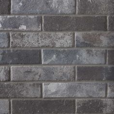 a brick wall made out of grey bricks