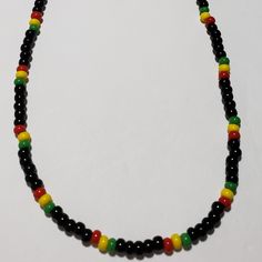 Jamaican/Rasta Colors Beaded Necklace Is Made With Size 6 Seed Bead Colors Are Opaque Cherry, Opaque Sunshine, Opaque Shamrock, And Black. 20 Inches In Length. Jamaican Beaded Necklace, Casual Black Beaded Necklaces For Festival, Black Beaded Necklace With Colorful Beads For Festivals, Festival Black Beaded Necklace With Colorful Beads, Casual Black Beaded Necklace For Festivals, Black Beaded Chain For Festival, Black Large Beads For Festivals, Black Large Beads For Festival, Black Necklaces With Colorful Beads For Festivals