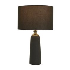 a table lamp with a black shade on it and a brown lampshade in the background