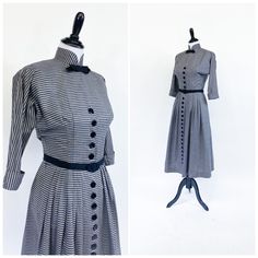 "A fabulously chic vintage day dress from the early 1950s! Medium weight cotton blend in horizontal black, white and gray stripes. Fitted waist and bloused bustline with cuffed ¾ length sleeves cut in one with the bodice. High Nehru collar accented with tailored grosgrain ribbon bow. A-line skirt with gathers at each hip, front and back. Dress closes up the front with a row of 22 buttons that extend from bust to hem. Small shoulder pads and short metal zipper at back neck. Unlined, missing origi Vintage Striped Fitted Dress, Vintage Striped Workwear Dresses, Vintage Striped Dress For Work, Vintage Striped Dresses For Work, Vintage Striped Dresses For Daywear, Cocktail Suit, Vintage Day Dress, Grosgrain Ribbon Bows, Afternoon Dress