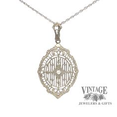 The detail of this antique vintage 14 karat white gold filigree pendant is noteworthy as it offers a shield shape with filigree spokes from top to bottom in a linear design. The filigree is joined by 6 small fleur-des-lis and 2 floral designs. The .02 carat single cut SI quality diamond is illusion set in a small diamond shape inset in the center of the pendant while the scallopped and reeded edge gives it even more character. The pendant is suspended from a milgrain etched bale on a 18" fine op Linear Design, Filigree Pendant, Gold Filigree, Diamond Shape, Rope Chain, Quality Diamonds, Floral Designs, Spring Rings, Antique Vintage