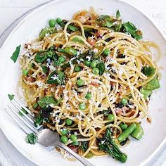 a white plate topped with pasta and veggies