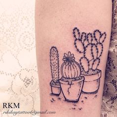 a small cactus tattoo on the right thigh, with three cacti in pots