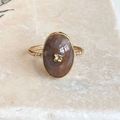 An antique 9 carat gold ring with an Agate  Cabochon stone. This beautiful piece holds a really interesting agate in the centre of a very simple setting, with gold detailing in the middle. The gold going through the Agate is a floral detail and looks really effective. CONDITION: Wear consistent with age and use. Little damage to gold flower. Please see photos for more detail. APPROX. SETTING: 11mm x 16mm SETTING HEIGHT (inc. stone): 5mm APPROX. BAND WIDTH: 2mm RING SIZE: UK: T | US: 9 1/2 WEIGHT: 2.3 grams (VZZ) Chrysoprase Ring, Agate Cabochon, Gold Signet Ring, Cabochon Ring, Gold Flower, Ring Photos, Gold Diamond Rings, Gold Flowers, Gold Details