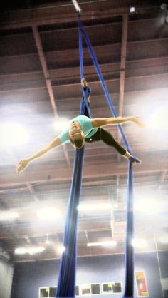 a woman is doing tricks on the high jump