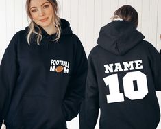 "Show your support with our Custom Football Mom Sweatshirt! Personalize it with your name and favorite player's number for a special touch. This Mother's Day, celebrate your role as the biggest fan with our cozy hoodie. It's the perfect gift for any football-loving mom. Order yours now and cheer on the team in style!" Hi all, welcome to the Comfy Tee Design, It's so nice to see you here. If you are looking for soft, comfy and high quality sweatshirts, I have good news for you: You're at the righ Sporty Crew Neck Hoodie For Team Events, Sporty Hoodie Sweatshirt For Team Events, Team Spirit Fleece Hoodie, Sporty Cotton Hoodie For Team Events, Black Football Season Sweatshirt With Team Name, Black Sweatshirt With Team Name For Football Season, Black Sweatshirt With Football Team Name, Black Football Season Sweatshirt, Black Fan Apparel Sweatshirt For Football Season