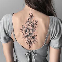 the back of a woman's neck with flowers on it