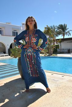 "A stunning embroidered Kaftan dress that is elegant, colorful, and unique! The dress is made of Egyptian cotton that has a soft feel to it so you will surely feel comfortable and royal in it. It also comes with a small invisible pocket on the right side of the Kaftan for added practicality. You can wear this Kaftan practically anywhere and for any occasion. You can dress it up with a pair of heels and strut like an Egyptian queen in any gathering, resort, or party. Or you can dress it down with Bohemian Blue Dresses With Geometric Embroidery, Blue Bohemian Dress With Geometric Embroidery, Embroidered Long Maxi Dress As Beach Cover-up, Long Embroidered Maxi Dress For Beach Cover-up, Summer V-neck Embroidered Abaya, Blue Dress With Embroidered Border For Festival, Summer Embroidered V-neck Abaya, Bohemian Long Thobe For Festivals, Bohemian Embroidered Abaya For Vacation