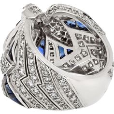 Immerse yourself in the world of luxury, where artistry and innovation converge in the Cartier 18K White Gold Diamond And Sapphire Dove Ring. This exquisite piece embodies elegance and grace, featuring a stunning dove motif crafted from 18K white gold, adorned with shimmering diamonds and vibrant sapphires. The intricate design captures the essence of love and freedom, making it a perfect symbol for cherished moments.Crafted by renowned designer Cartier, this ring is a testament to timeless beauty and exceptional craftsmanship. The diamonds and sapphires sparkle with every movement, creating a mesmerizing display of light and color. Whether worn as a statement piece or as a symbol of affection, this ring is sure to captivate hearts and turn heads wherever you go.Indulge in sophistication a Luxury Sapphire Diamond Ring With Diamond Cut, Cartier Luxury White Gold Diamond Ring, Luxury Cartier White Gold Diamond Ring, Luxury Diamond Cut Diamond Ring, Luxury Sapphire Diamond Ring With 17 Jewels, Luxury Polished Diamond Ring For Wedding, Luxury Diamond Ring With Polished Finish, Luxury Polished Finish Diamond Wedding Ring, Luxury Sapphire Cluster Ring