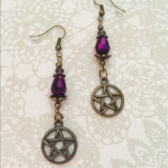 Gorgeous Earrings With A Fire Polished Crystal Drop Topped With Brass Ornate Bead Caps. Small Deep Purple Czech Crystal And Brass Pentagram Charms. Finished With Fish Hooks. Approximately 2.5 Inches Top Of Hook To Bottom Of Charm. Purple Bohemian Crystal Earrings, Purple Metal Crystal Earrings As Gift, Purple Crystal Metal Earrings For Gifts, Nickel-free Purple Earrings For Festival, Purple Metal Crystal Earrings For Gift, Nickel Free Purple Earrings For Festival, Purple Drop Crystal Earrings, Purple Metal Earrings, Adjustable Purple Metal Earrings