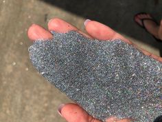 a person holding glitter in their hand