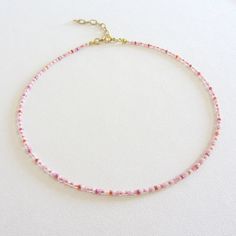 Pink seed beaded choker necklace, Stainless steel jewelry, Handmade boho jewelry, Birthday gift for woman There are two clasp options: stainless steel clasp and chain, the clasp and chain are made of brass with 14k gold plating, so the necklace will not lose its look over time! The length of the necklace is 13 inches with an adjustable chain that is 2 inches long. The full length is 15 inches. The necklace is made of pink and white beads with a diameter of about 2 mm. Measure the length of your neck with a measuring tape or use any twine, twine or telephone cable and then draw the measurements on a regular ruler. If you would like a different necklace, I can customize it for you. Gift Choker With Spacer And Heishi Beads, Handmade Heishi Beads Choker As Gift, Handmade Heishi Bead Choker Perfect As A Gift, Bohemian Heishi Beads Choker As Gift, Adjustable Heishi Beads Choker As Gift, Bohemian Choker With Tiny Beads For Gift, Gift Heishi Beads Choker Jewelry, Heishi Beads Choker Jewelry Gift, Delicate Beaded Necklaces With Tiny Beads For Gifts