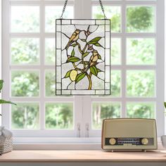 a stained glass window hanging over a kitchen counter