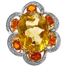 Centering an approximately ~7 carat Orangy-Yellow Oval-Cut Citrine, set in 14K Yellow/White Gold, and accented by six oval-cut orange Citrines and 30 round-brilliant cut diamonds Details: ✔ Stone: Citrine ✔ Stone Cut: Oval, Brilliant ✔ Stone Weight: 7 carats (center stone) ✔ Setting: 14K Yellow/White Gold ✔ Ring: 6 pcs Oval-cut Citrine, ~1 carat total; 30pc round-cut diamonds ✔ Dimensions 2.8cm x 1.8cm ✔ Ring Size: 7 U.S. ✔ Total Weight: 7.6g Luxury Multi-stone Yellow Gemstones, Luxury Yellow Multi-stone Gemstones, Luxury Yellow Gold Topaz Ring With Diamond Accents, Fine Jewelry Yellow Gold Round Cut Gemstones, Yellow Multi-stone Round Gemstones, Yellow Diamond Gemstone Ring Fine Jewelry, Luxury Multi-stone Yellow Diamond Ring, Yellow Diamond Ring In 14k Gold, 14k Gold Yellow Diamond Ring