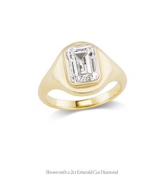 a yellow gold ring with an emerald cut diamond in the center, on a white background