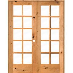 an open wooden door with glass panels on the front and side doors, all in light wood