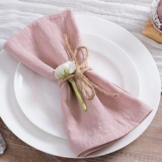 a white plate topped with a pink napkin