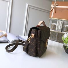 For Summer 2020, the stylish Pochette Métis handbag in Monogram canvas features a braided-leather top handle, its leather edge-dyed by hand. An oversized LV leather charm and the S-lock closure, inspired by historic Louis Vuitton trunks, finish this compact bag. A detachable canvas strap translates into comfortable shoulder and cross-body wear. Detailed Features 25.0 x 19.0 x 7.0 cm( length x height x width ) Monogram coated canvas Smooth cowhide-leather trim Microfiber lining Gold-color hardwar Louis Vuitton Trunks, Pochette Louis Vuitton, Louis Vuitton Trunk, Louis Vuitton Pochette Metis, Compact Bag, Louis Vuitton Pochette, Monogram Bag, Braided Leather, Handle Bag