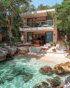 the house is surrounded by trees and rocks