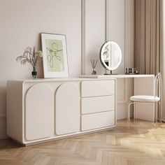 a white dresser sitting next to a mirror on top of a wooden floor in a room