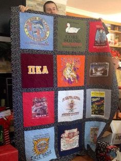 a man is holding up a quilt made with t - shirts