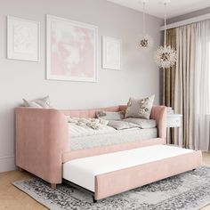 a living room with a couch, rug and pictures hanging on the wall above it