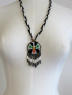 Vintage Navajo Wedding Basket Thunderbird Design Glass Beads Necklace Pendant. Backed by leather. Dimensions of necklace: Width 50mm (2") Height 75mm (3" including drops) Length 24" Please check out my other designs and vintage pieces here: https://www.etsy.com/uk/shop/YouGotTheSilverUK  Click on customise for any custom queries or bespoke pieces. Teardrop Beaded Necklaces For Festivals, Bohemian White Jewelry With Black Beads, Artisan Teardrop Beaded Necklace, Southwestern Style Adjustable Teardrop Necklace, Southwestern Necklaces With Dangling Beads And Adjustable Fit, Southwestern Necklaces With Dangling Beads, Southwestern Necklace With Dangling Beads And Adjustable Fit, Southwestern Style White Jewelry With Dangling Beads, Festival Teardrop Jewelry With Large Beads