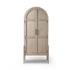 an arched wooden cabinet with two doors